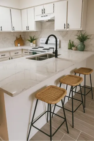 a kitchen with stainless steel appliances granite countertop a table and chairs