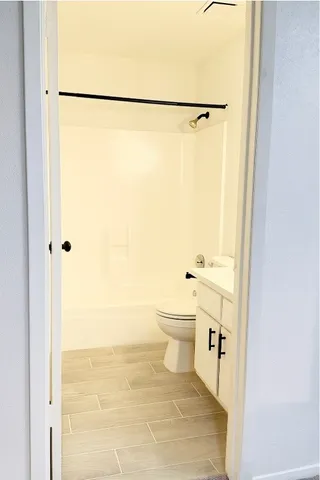 a bathroom with a shower toilet and sink