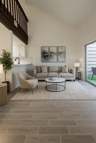 a living room with furniture and a potted plant