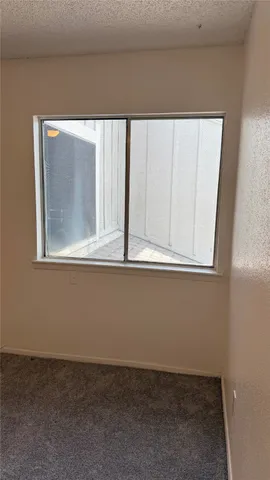 a view of an empty room and a window