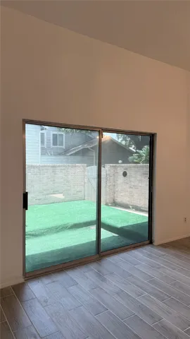 a view of a room with wooden floor and a carpet