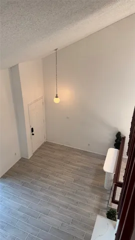 a view of an empty room and wooden floor