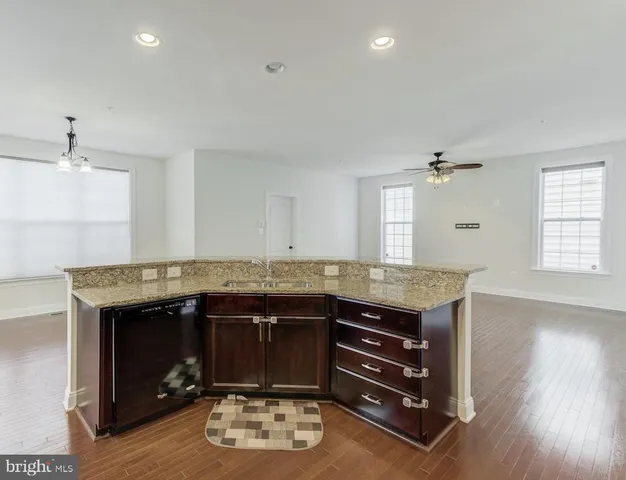 a kitchen with a stove and a wooden floor