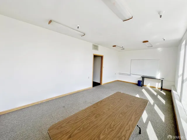 a view of a kitchen with a stove cabinets and wooden floor
