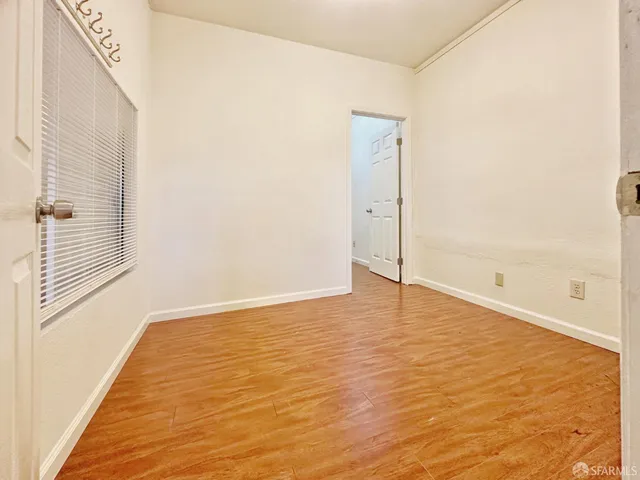 an empty room with wooden floor