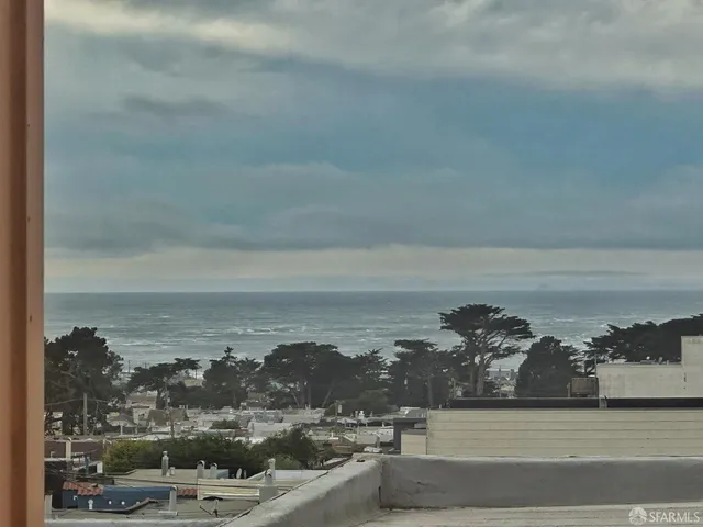 a kitchen with granite countertop a sink cabinets and stainless steel appliances