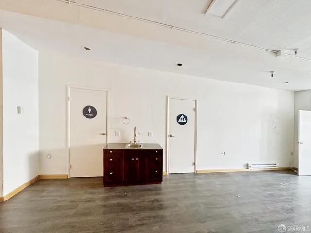 a bathroom with a granite countertop sink toilet and mirror