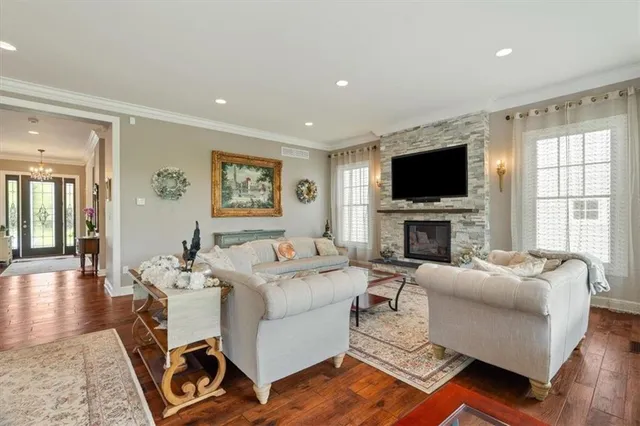 a living room with fireplace furniture and a flat screen tv