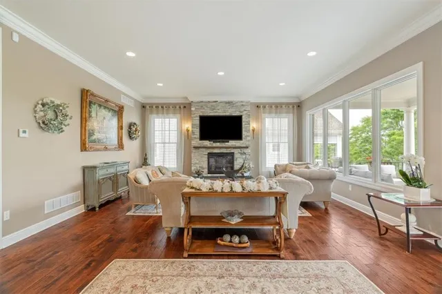 a living room with furniture a flat screen tv and a large window