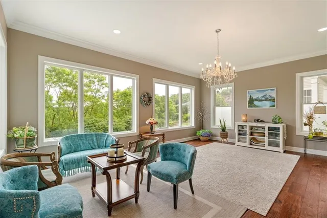 a living room with furniture and a chandelier