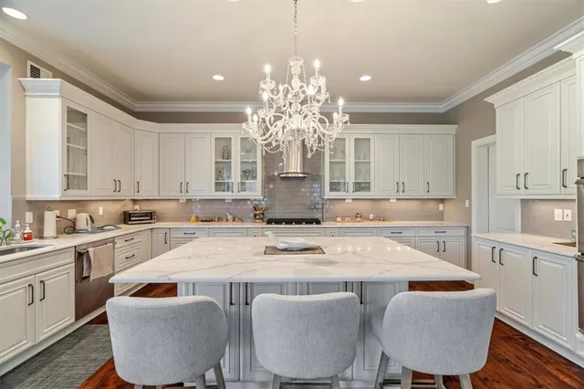 a view of kitchen with granite countertop cabinets a dining table and chairs