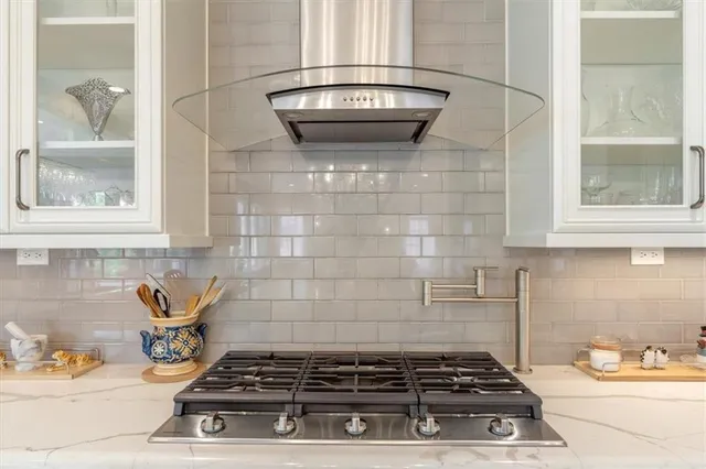 a stove top oven sitting inside of a kitchen