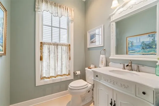 a bathroom with a sink a toilet and a window