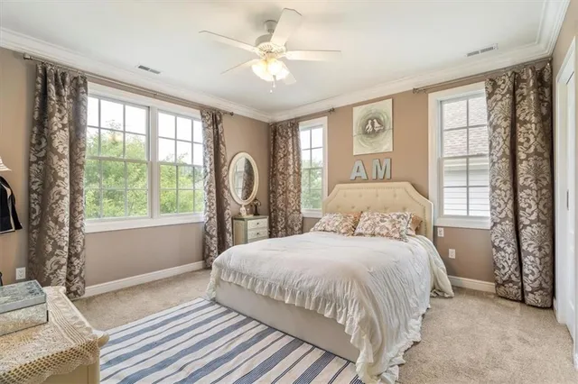 a bedroom with a large bed and a large window