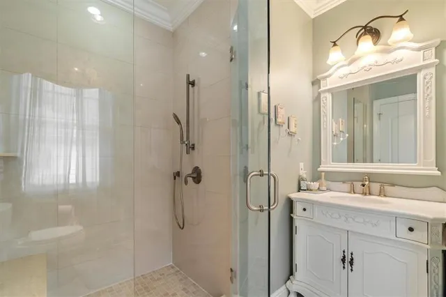 a bathroom with a double vanity sink mirror and shower