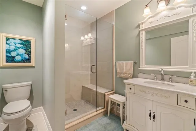 a bathroom with a sink toilet a mirror and shower