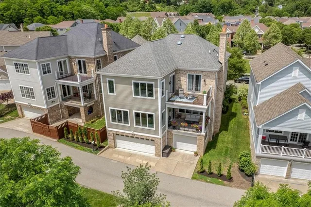 an aerial view of a house with a garden and trees