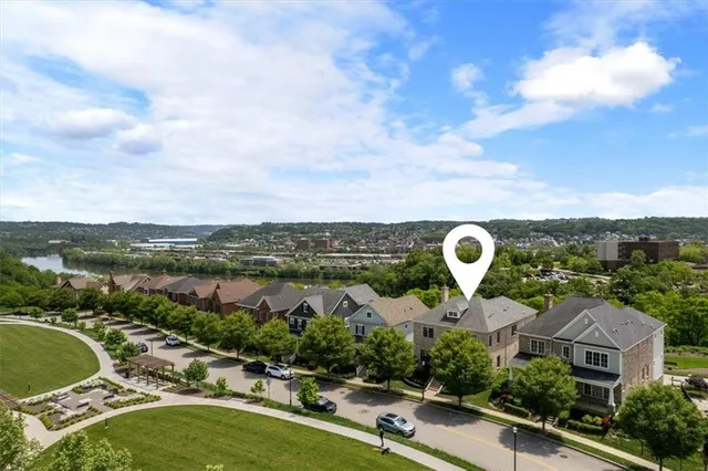an aerial view of a house with a garden and lake view