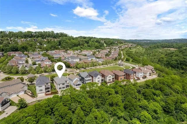 an aerial view of a house with garden space and street view