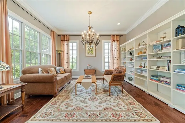a living room with furniture and a chandelier