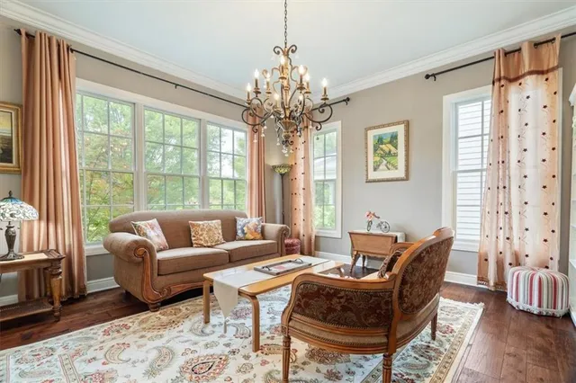 a living room with furniture and a chandelier