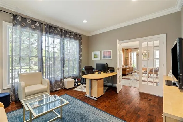 a living room with fireplace furniture and a large window