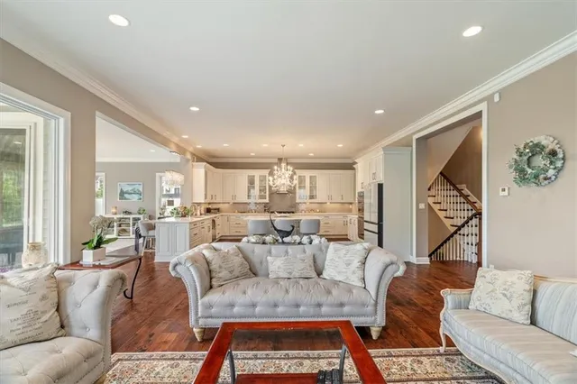 a living room with furniture a rug and a chandelier
