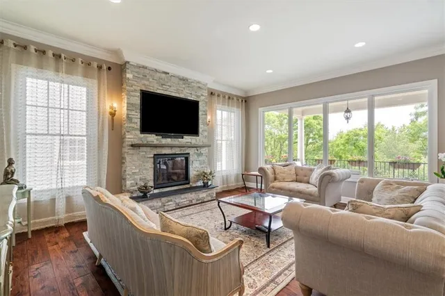 a living room with fireplace furniture and a flat screen tv