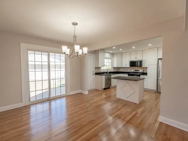 a view of kitchen with refrigerator and window