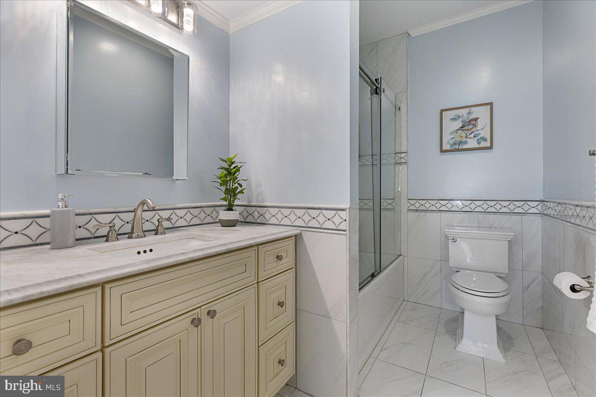 535 Village Road West Princeton Junction, NJ 08550 - Photo 17 of 51 a spacious bathroom with a granite countertop sink a toilet and a mirror