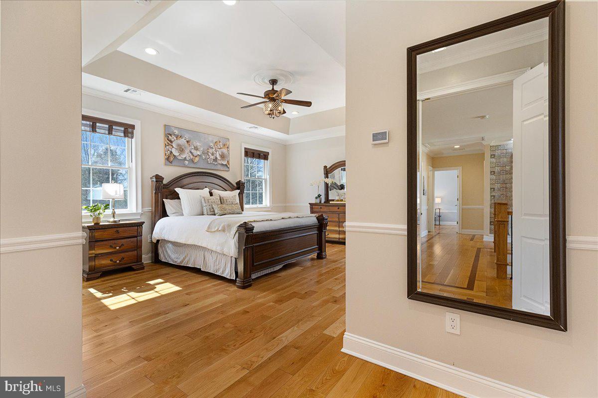 535 Village Road West Princeton Junction, NJ 08550 - Photo 21 of 51 a bedroom with a large bed and a chandelier