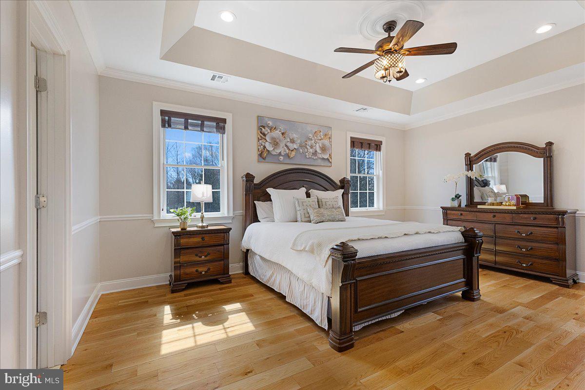 535 Village Road West Princeton Junction, NJ 08550 - Photo 22 of 51 a bedroom with a bed and a chandelier
