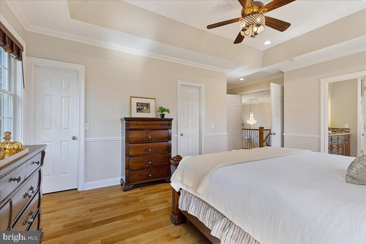 535 Village Road West Princeton Junction, NJ 08550 - Photo 23 of 51 a bedroom with a bed and a chandelier