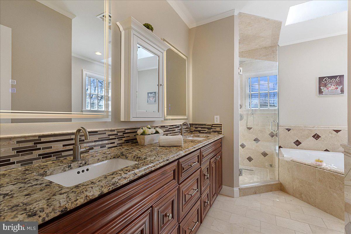 535 Village Road West Princeton Junction, NJ 08550 - Photo 24 of 51 a bathroom with a granite countertop double vanity sink and mirror with bathtub