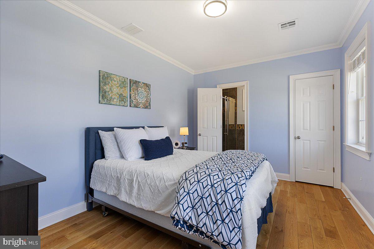 535 Village Road West Princeton Junction, NJ 08550 - Photo 26 of 51 a bedroom with a bed and a painting on the wall