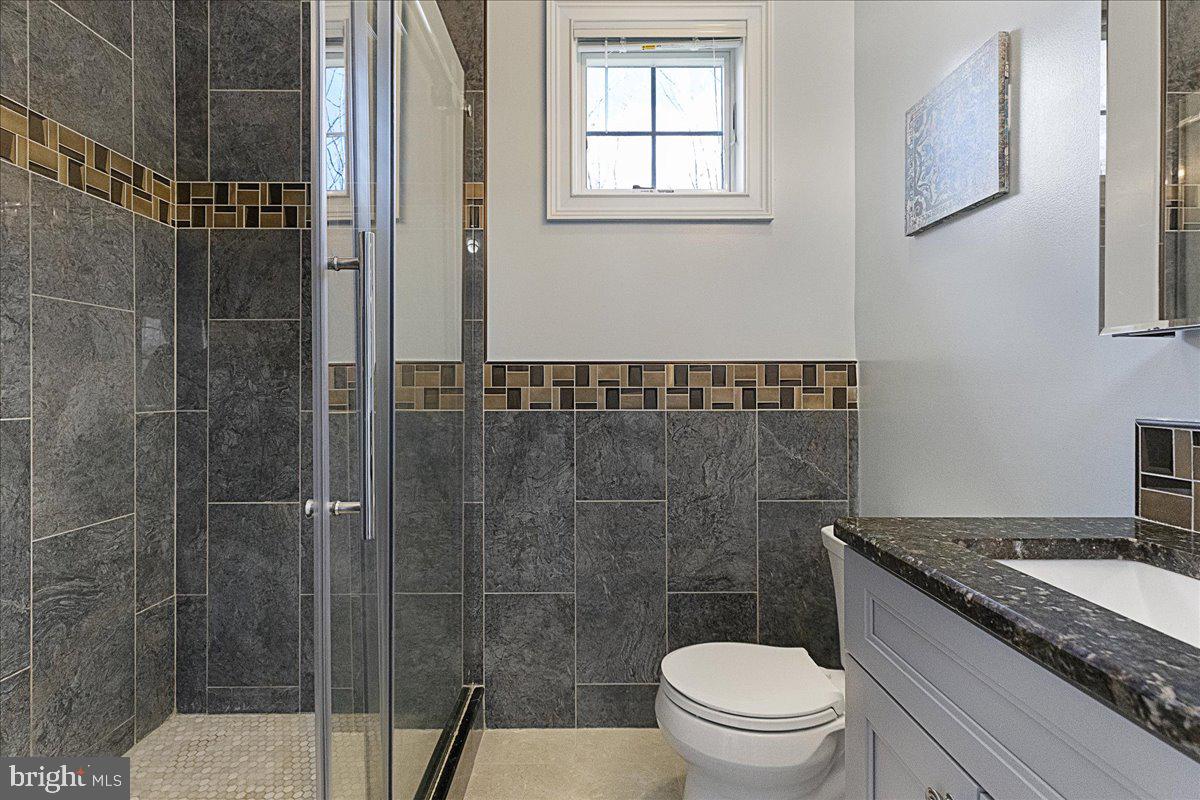 535 Village Road West Princeton Junction, NJ 08550 - Photo 27 of 51 a bathroom with a granite countertop sink a toilet and shower