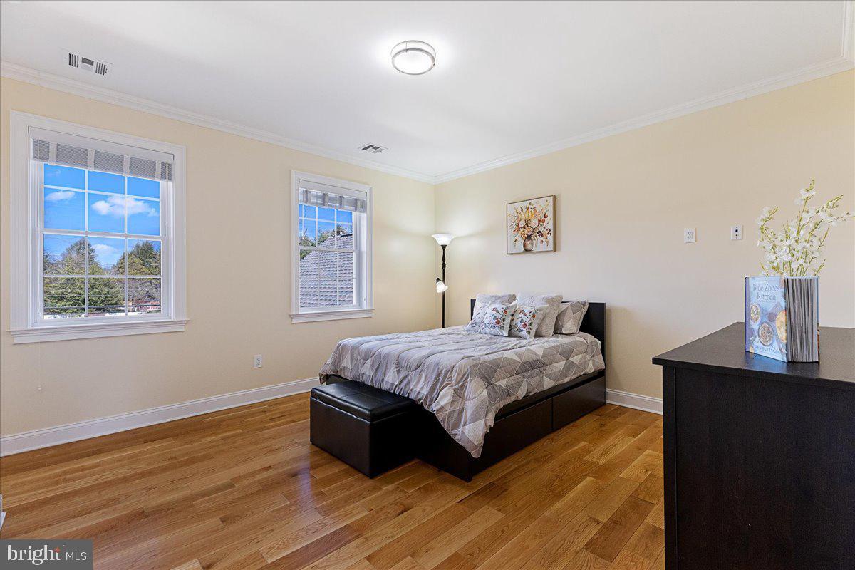535 Village Road West Princeton Junction, NJ 08550 - Photo 28 of 51 a bedroom with a bed and wooden floor