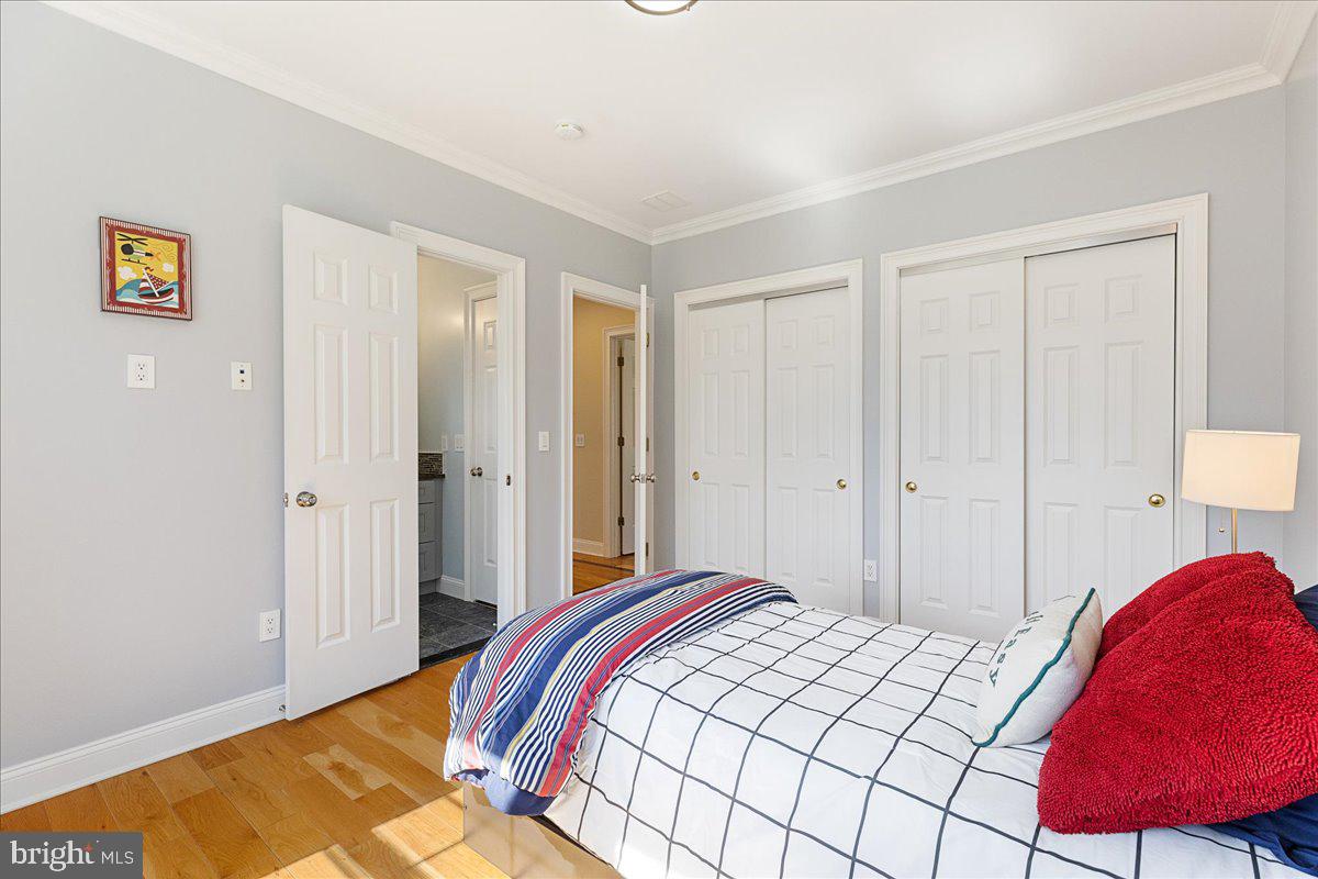 535 Village Road West Princeton Junction, NJ 08550 - Photo 31 of 51 a bedroom with a bed and a lamp on dresser