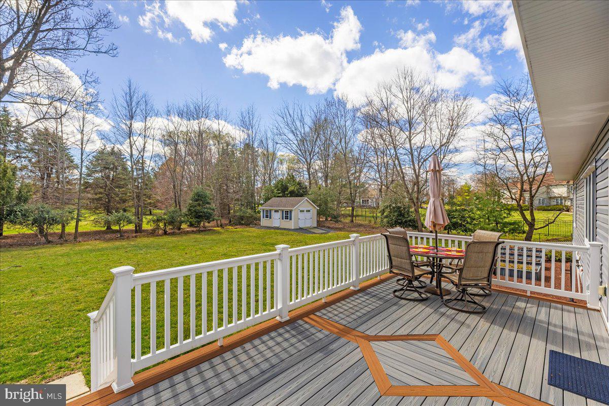 535 Village Road West Princeton Junction, NJ 08550 - Photo 37 of 51 a view of a patio with dining table and chairs with wooden floor and fence