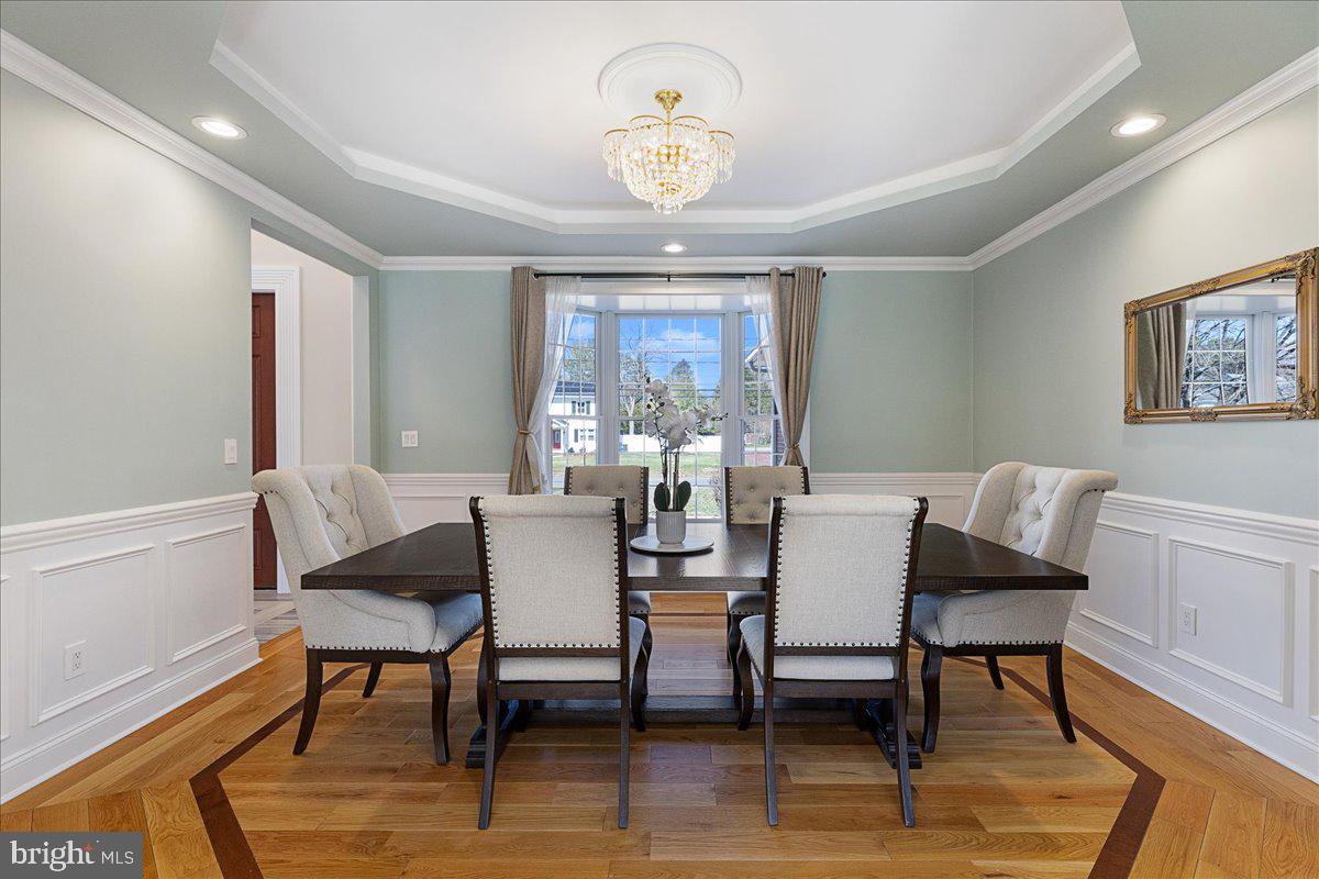 535 Village Road West Princeton Junction, NJ 08550 - Photo 7 of 51 a dining room with furniture a chandelier and wooden floor