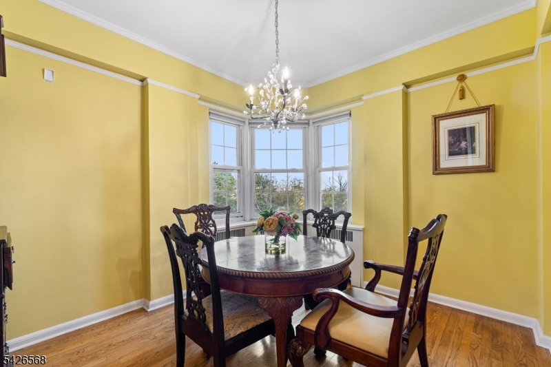 10 Crestmont Road, Unit 3L Montclair, NJ 07042 - Photo 16 of 41 a view of a dining room with furniture and chandelier