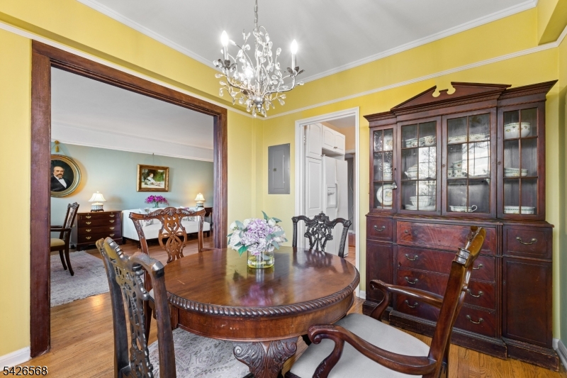 10 Crestmont Road, Unit 3L Montclair, NJ 07042 - Photo 17 of 41 a dining room with furniture a chandelier and wooden floor