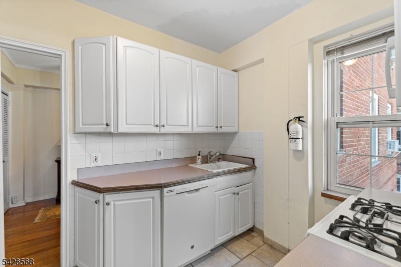 10 Crestmont Road, Unit 3L Montclair, NJ 07042 - Photo 18 of 41 a view of a sink and dishwasher with wooden floor