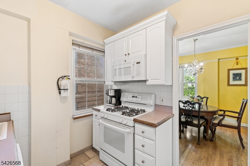 10 Crestmont Road, Unit 3L Montclair, NJ 07042 - Photo 19 of 41 a kitchen with cabinets appliances and a dining table