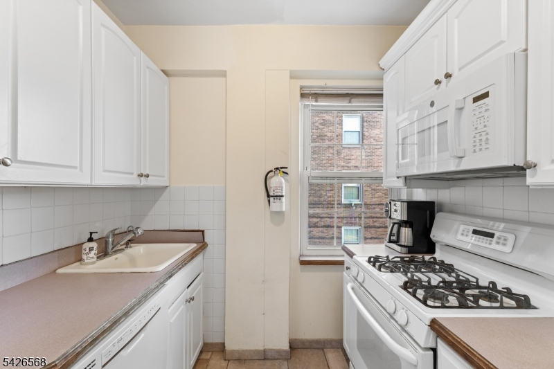 10 Crestmont Road, Unit 3L Montclair, NJ 07042 - Photo 20 of 41 a kitchen with stainless steel appliances a stove a sink and a refrigerator