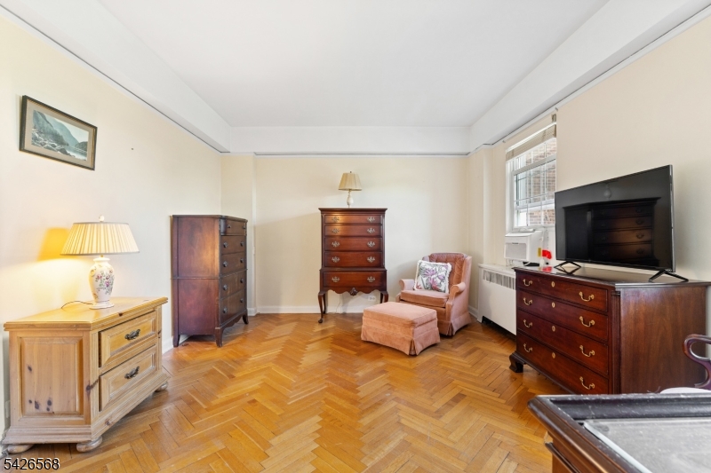 10 Crestmont Road, Unit 3L Montclair, NJ 07042 - Photo 22 of 41 a bedroom with furniture and a flat screen tv