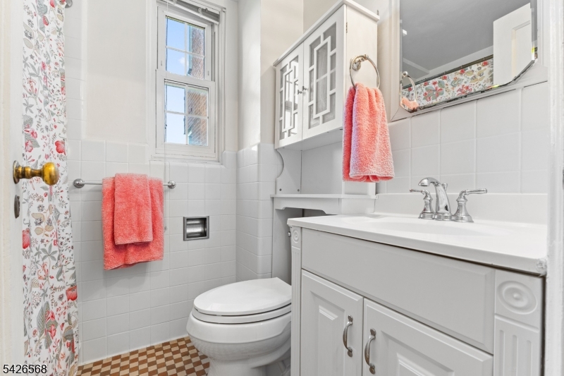 10 Crestmont Road, Unit 3L Montclair, NJ 07042 - Photo 25 of 41 a bathroom with a sink vanity mirror and toilet