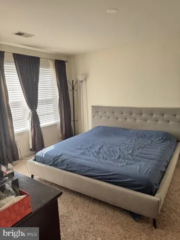 a living room with a bed furniture and a large window