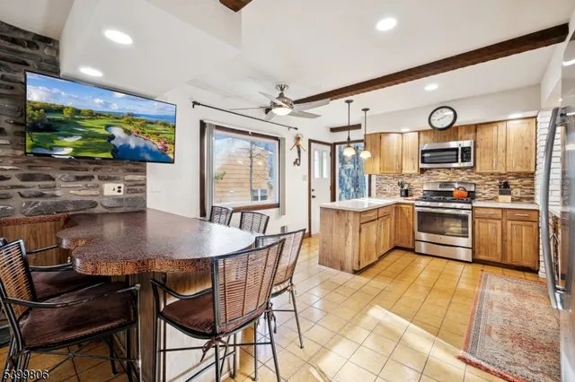 a kitchen with stainless steel appliances kitchen island granite countertop a sink and a stove