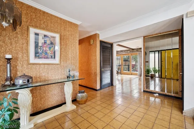 a view of a hallway with wooden floor and furniture